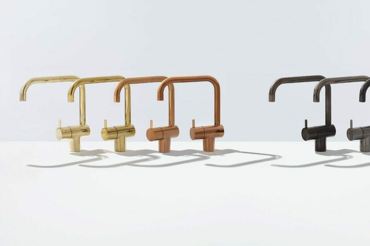 Six design taps in gold, copper and gray tones in a row.